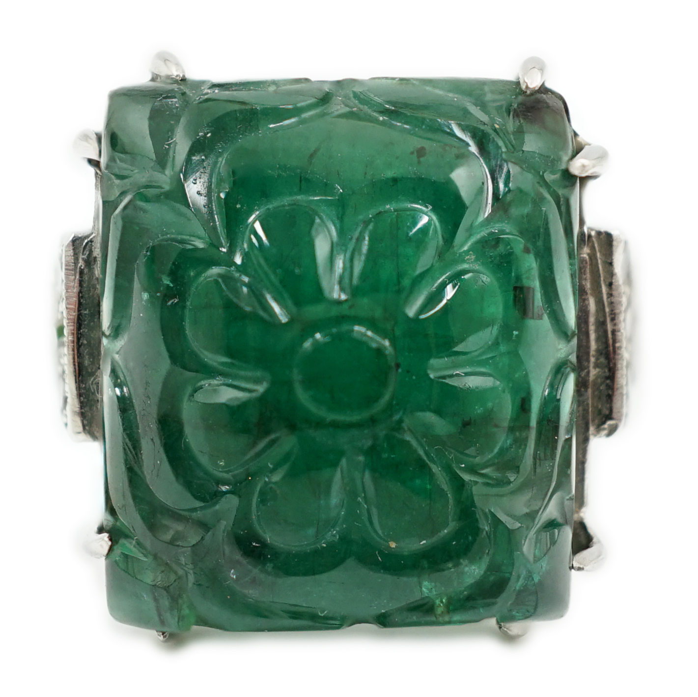 A French 1920's style platinum and single stone emerald set dress ring, with twelve stone millegrain set diamond stepped shoulders